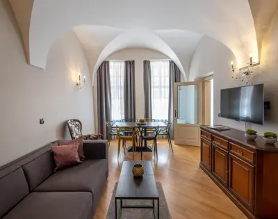 a living room with a couch and a table at Chateau 9 Apartments by Adrez in Prague