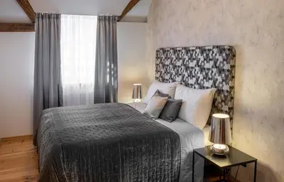 a bedroom with a large bed and a window at Chateau 9 Apartments by Adrez in Prague