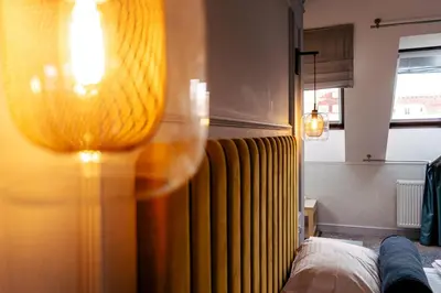 a room with a bed and a curtain and a window at The Hotel Fitzgerald in Prague