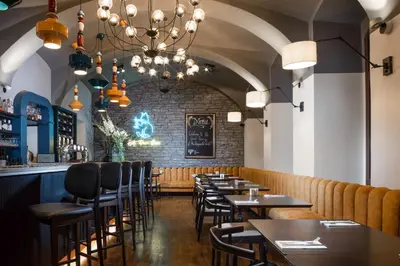 a row of tables and chairs in a restaurant at The Hotel Fitzgerald in Prague
