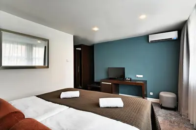 a bedroom with a bed with two towels on it at The Hotel Fitzgerald in Prague