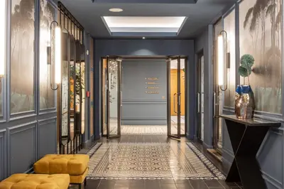 a hallway with blue walls and a door at The Hotel Fitzgerald in Prague