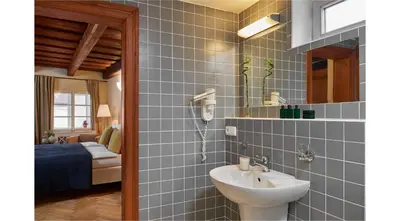 a bathroom with a sink and a mirror at Mostecká 12 Residence in Prague