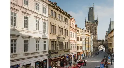 a city street with buildings and a clock tower at Mostecká 12 Residence in Prague