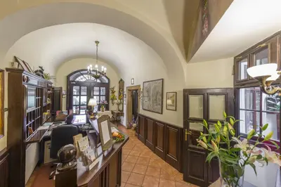 an office with a desk in a room with windows at Hotel Cerny Slon in Prague