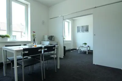a dining room with a table and chairs at Apartman Amanda in Poděbrady