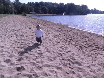 a young boy walking on the beach at Apartman Amanda in Poděbrady