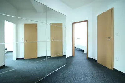 an empty room with glass doors and a mirror at Apartman Amanda in Poděbrady