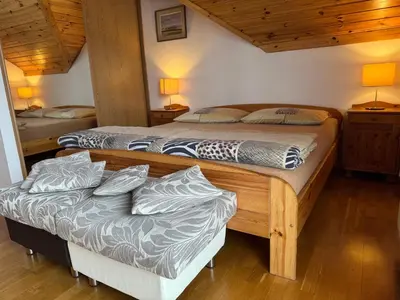 two twin beds in a room with wooden ceilings at Dům Stašov in Stašov
