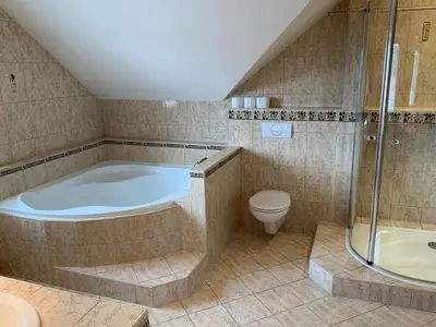 a large bathroom with a tub and a toilet at Dům Stašov in Stašov