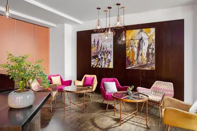 a room with chairs and tables and a painting at Clarion Hotel Prague City in Prague