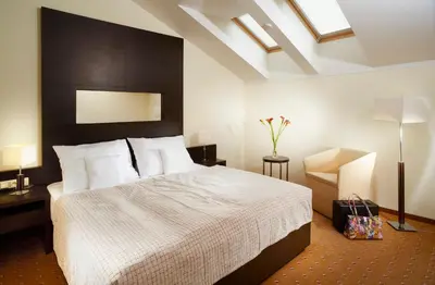 a bedroom with a large bed with a black headboard at Clarion Hotel Prague City in Prague