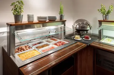 a kitchen with a buffet with eggs and food at Clarion Hotel Prague City in Prague
