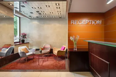 a reception area of a hotel with chairs and a table at Clarion Hotel Prague City in Prague