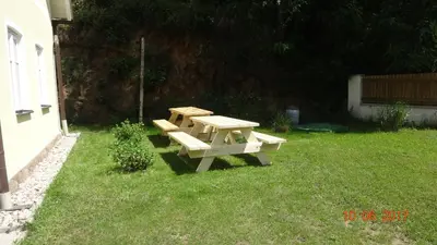 a picnic table in the grass in a yard at Chaloupka za potůčkem in Županovice
