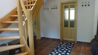 a staircase leading up to a room with a door at Chaloupka za potůčkem in Županovice