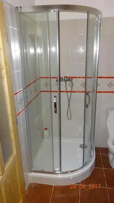 a shower with a glass door in a bathroom at Chaloupka za potůčkem in Županovice