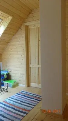 an attic room with a rug on the floor at Chaloupka za potůčkem in Županovice