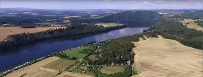 an aerial view of a river and a town at Chaloupka za potůčkem in Županovice