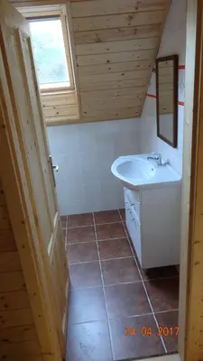 a bathroom with a sink and a toilet and a mirror at Chaloupka za potůčkem in Županovice