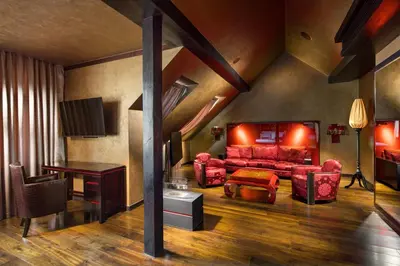 a living room with a red couch and a table at Buddha-Bar Hotel Prague in Prague