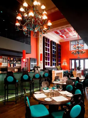 a restaurant with tables and chairs and a bar at Buddha-Bar Hotel Prague in Prague