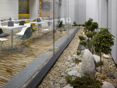 a garden in the middle of a room with tables and chairs at MOODs boutique hotel in Prague
