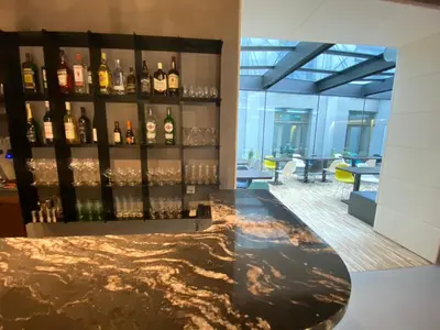 a lobby with a bar with wine bottles at MOODs boutique hotel in Prague