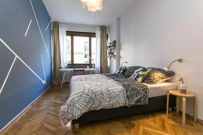 a bedroom with a bed in a room with blue walls at Apartments Stepanska 36 in Prague