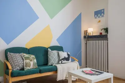 a living room with a green couch and a table at Apartments Stepanska 36 in Prague