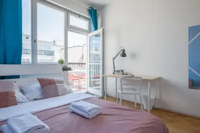 a bedroom with a bed and a desk and a window at Apartments Stepanska 36 in Prague