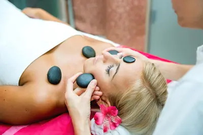 a woman laying on a bed with pills on her face at Château Liblice in Byšice