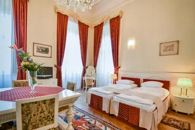 a hotel room with two beds and a table at Château Liblice in Byšice