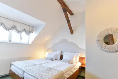 a bedroom with a bed and a mirror on the wall at Château Liblice in Byšice