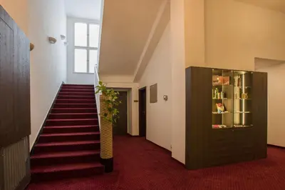 a staircase in a building with a plant at Hotel Bellevue Tlapak in Poděbrady