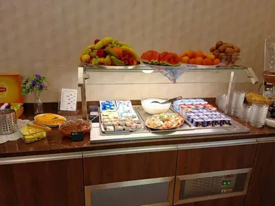 a buffet with many different types of food on a counter at Hotel Bellevue Tlapak in Poděbrady