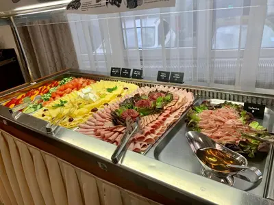 a buffet line with many different types of food at Hotel Bellevue Tlapak in Poděbrady