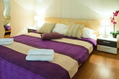 a bedroom with a large bed with towels on it at Apartment Jindrisska 25 in Prague