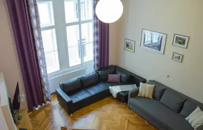 a living room with a couch and a large window at Apartment Jindrisska 25 in Prague