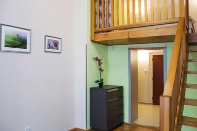 a room with a staircase and a dresser with a plant on it at Apartment Jindrisska 25 in Prague