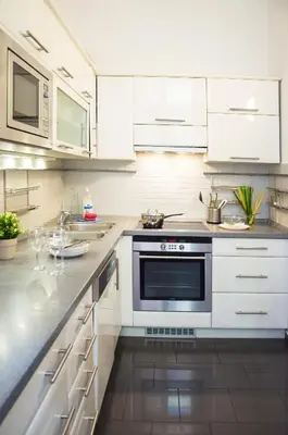 a kitchen with white cabinets and a stove at Apartment Jindrisska 25 in Prague