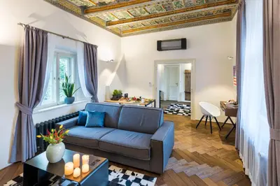 a living room with a couch and a table at MOOo by the Castle in Prague