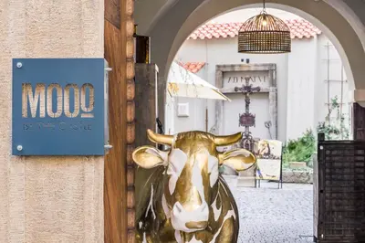 a statue of a cow on the door of a house at MOOo by the Castle in Prague