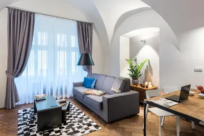 a living room with a couch and a table at MOOo by the Castle in Prague