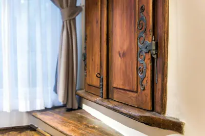 a wooden door in a room with a window at MOOo by the Castle in Prague