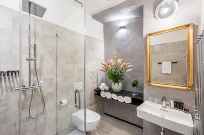 a bathroom with a shower and a toilet and a sink at MOOo by the Castle in Prague