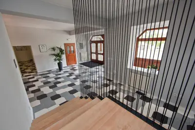 a hallway with a black and white checkered floor at Rozmaryn Rooms & Apartments in Rakovník