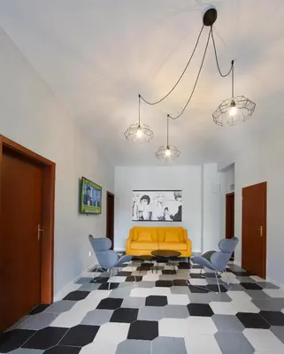 a living room with a yellow couch and two chairs at Rozmaryn Rooms & Apartments in Rakovník