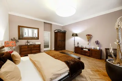 a bedroom with a large bed and a mirror at LUXURY Apartment Dlouha in Prague