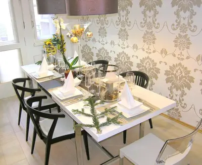 a white table with black chairs and flowers on it at LUXURY Apartment Dlouha in Prague